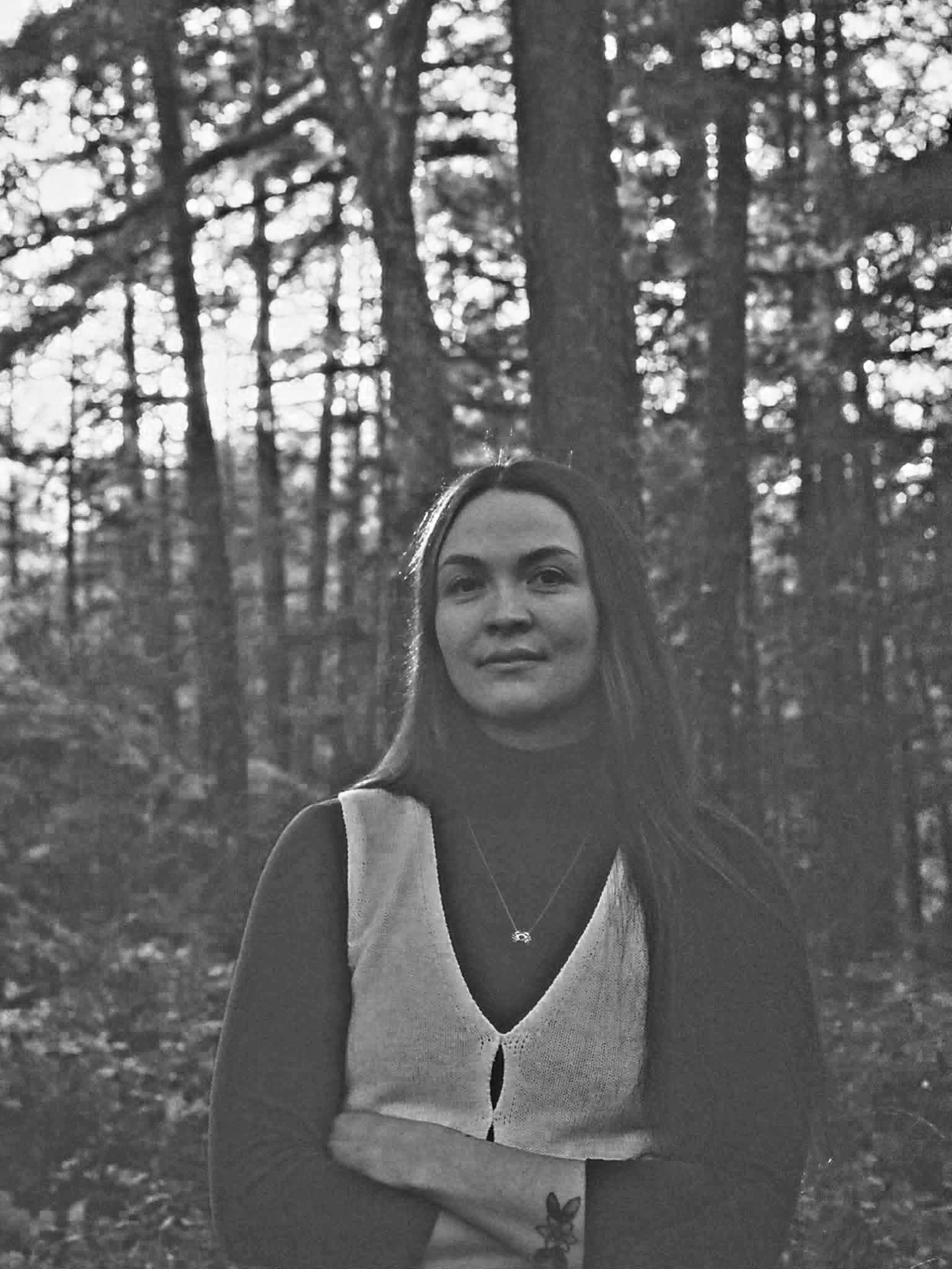 Team member Hannah Gentes in a forest setting.
